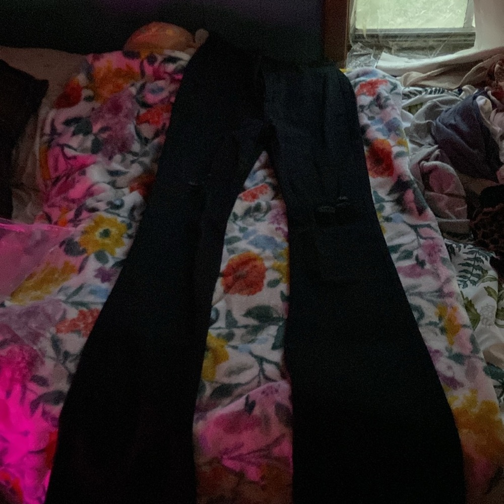 Women’s small black flared jeans with rips.